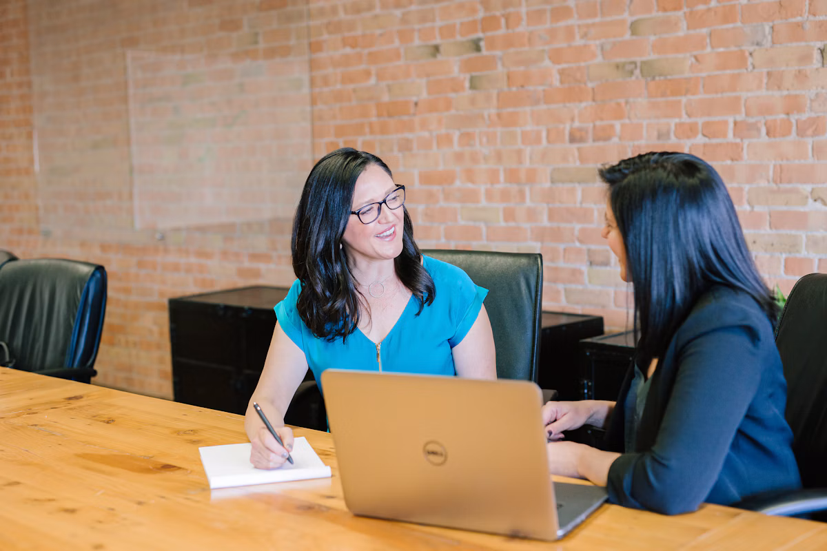 Professional reviewing work at a computer